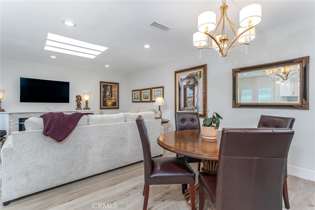 74 Calle Aragon, Unit B Laguna Woods, CA 92637 - Photo 9 of 22 a living room with furniture a flat screen tv and kitchen view