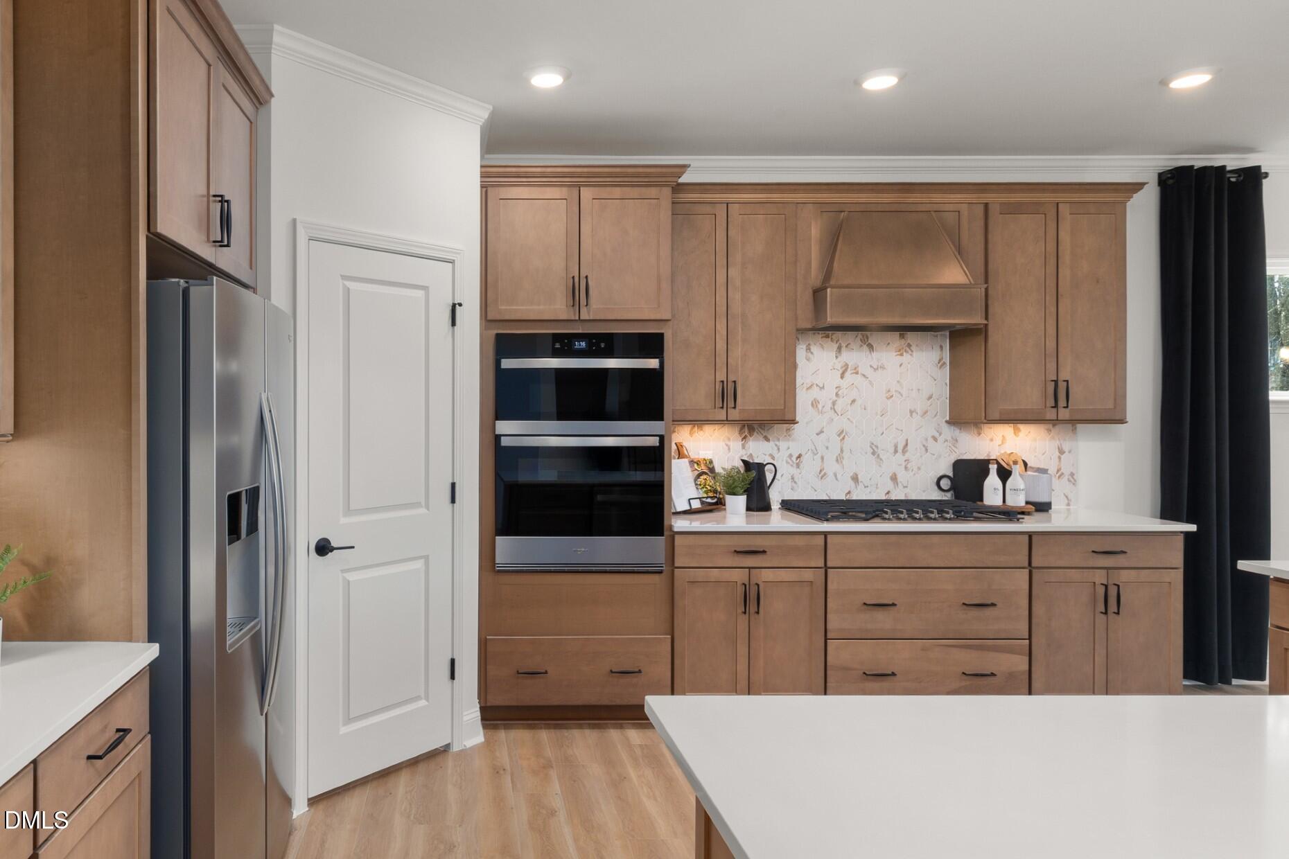 3105 Warhorse Road Fuquay-Varina, NC 27526 - Photo 6 of 31 a kitchen with stainless steel appliances a refrigerator sink and cabinets