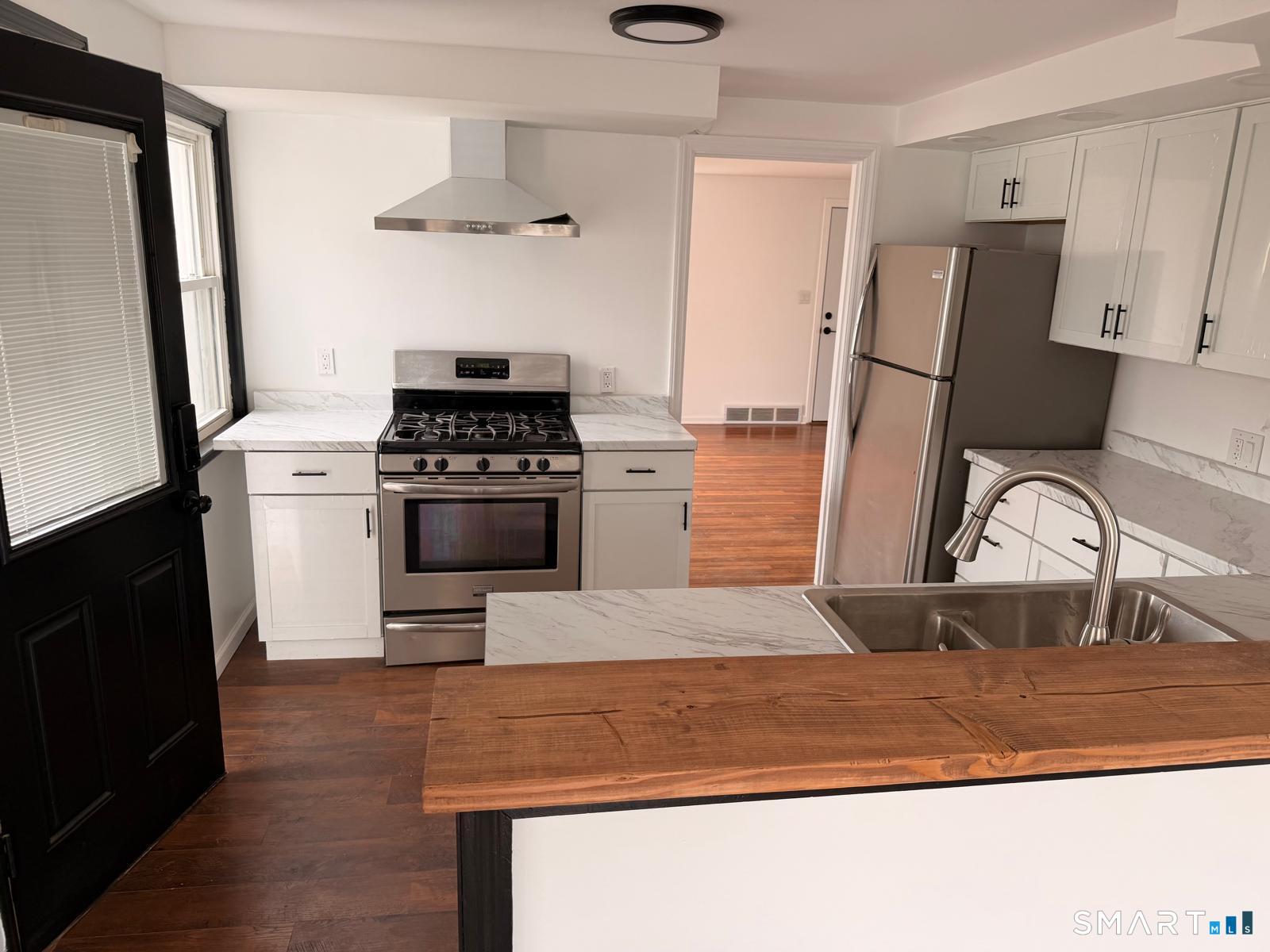 44 Lynmoor Place Hamden, CT 06517 - Photo 11 of 30 a kitchen with stainless steel appliances granite countertop a stove and a refrigerator