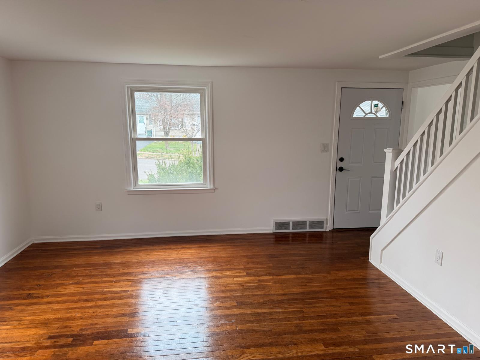 44 Lynmoor Place Hamden, CT 06517 - Photo 13 of 30 a view of an empty room with wooden floor and a window