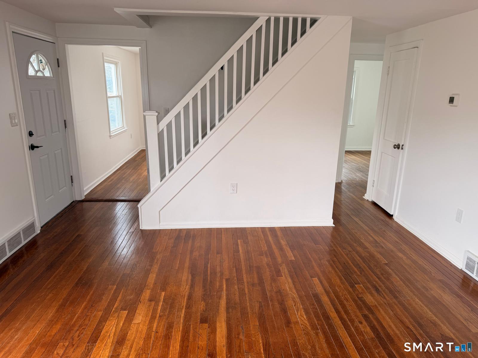 44 Lynmoor Place Hamden, CT 06517 - Photo 14 of 30 a view of a hallway with wooden floor and staircase
