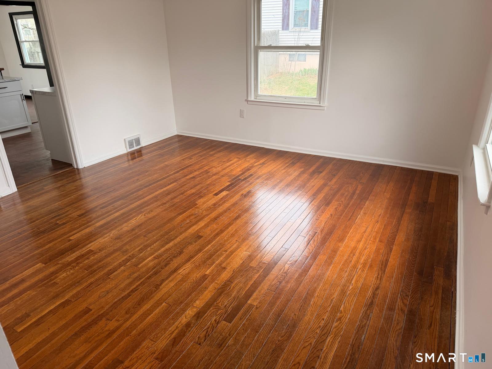 44 Lynmoor Place Hamden, CT 06517 - Photo 15 of 30 an empty room with wooden floor and windows