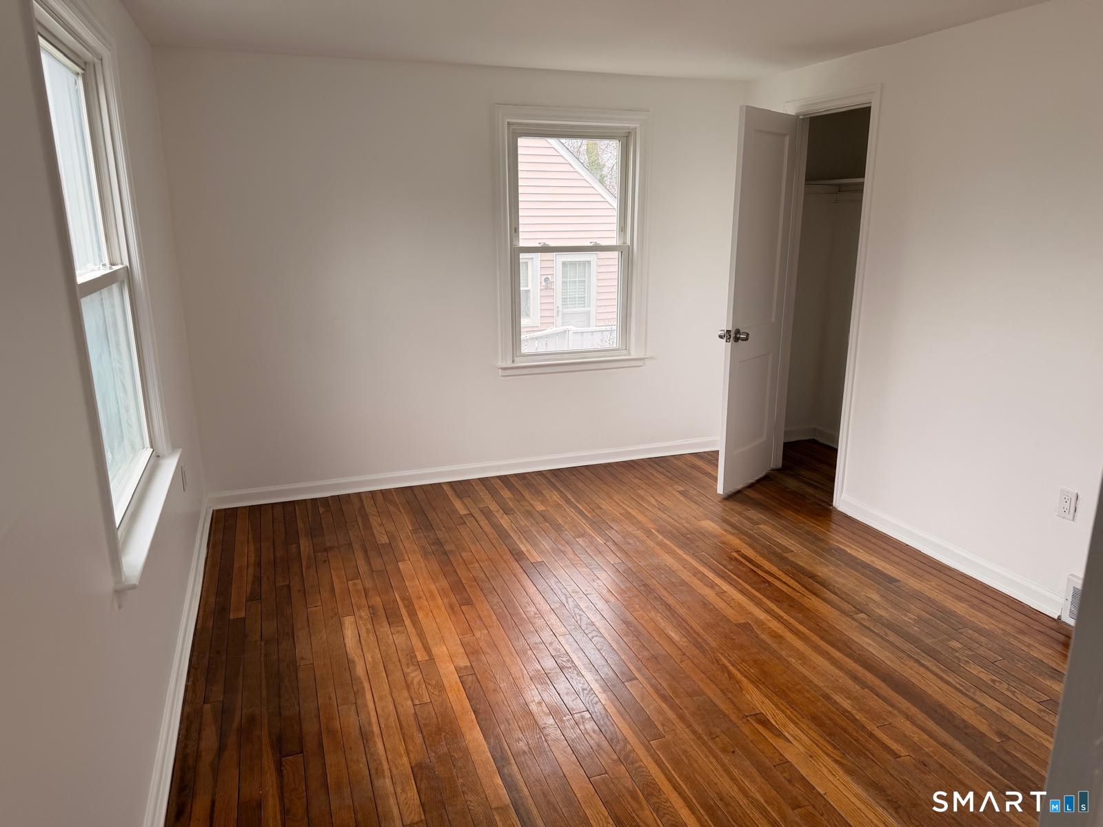 44 Lynmoor Place Hamden, CT 06517 - Photo 16 of 30 an empty room with wooden floor and windows