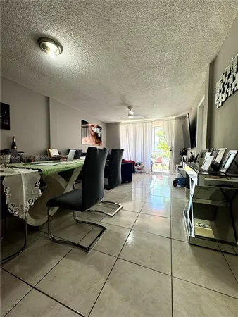 a living room with furniture and a gym machine