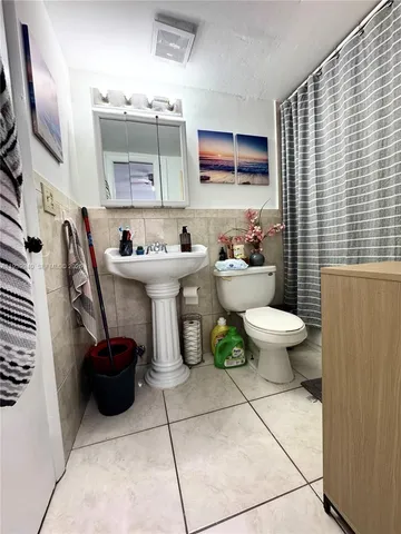 a bathroom with a sink a toilet and mirror