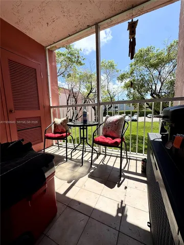 a building outdoor space with patio furniture and potted plants