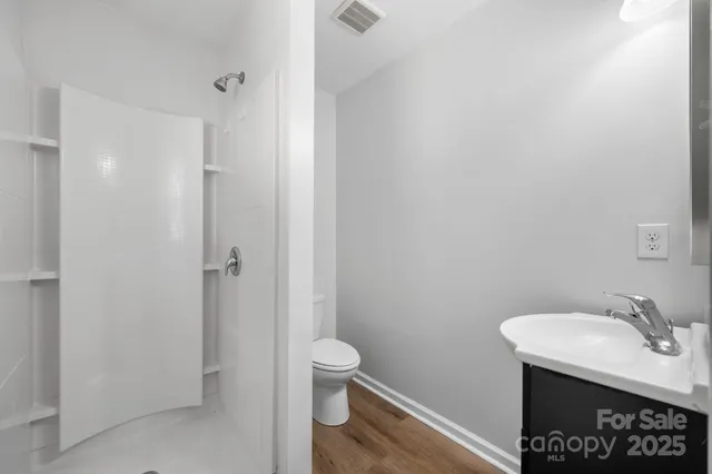 a bathroom with a sink toilet and vanity