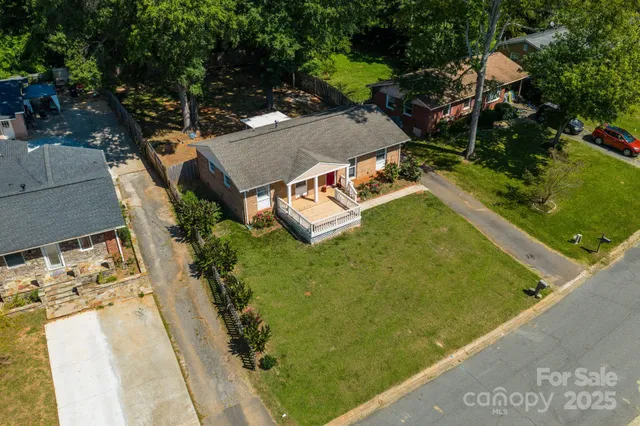 an aerial view of a house with garden space and street view