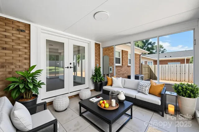 a living room with furniture potted plant and a table