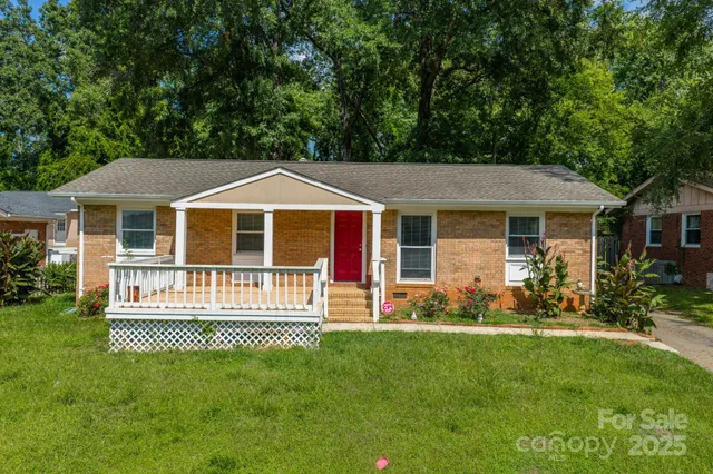 a front view of a house with a garden and porch