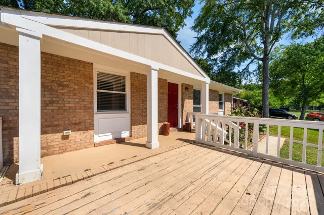 a view of a house with pool and wooden floor