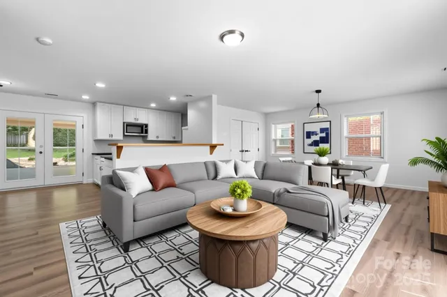 a living room with furniture and kitchen view