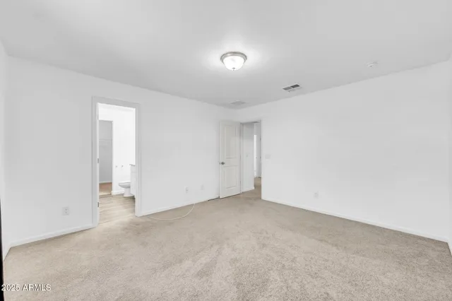 a bathroom with a granite countertop sink and a toilet