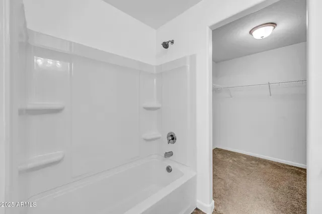 a bathroom with a bathtub and shower