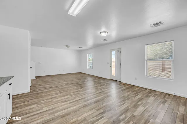 a view of kitchen with wooden floor and electronic appliances