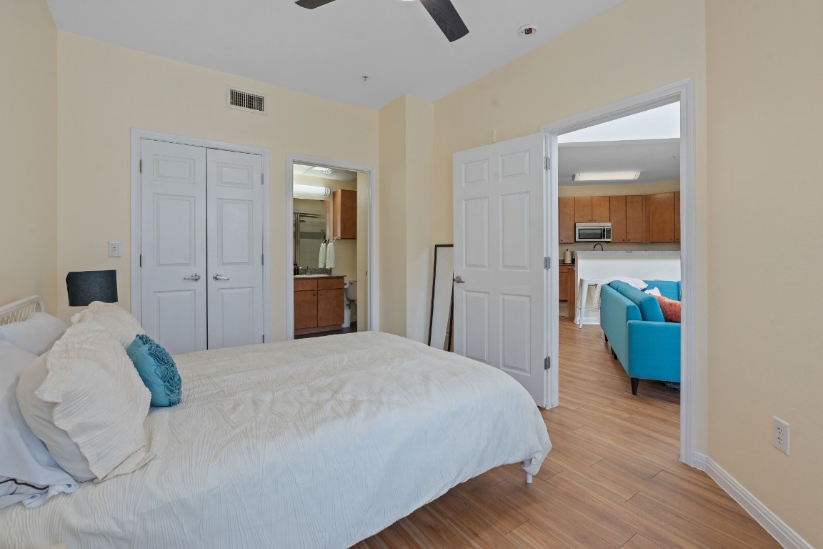 2502 Leon Street, Unit 501 Austin, TX 78705 - Photo 14 of 14 Bedroom with light wood-type flooring, a closet, and a ceiling fan
