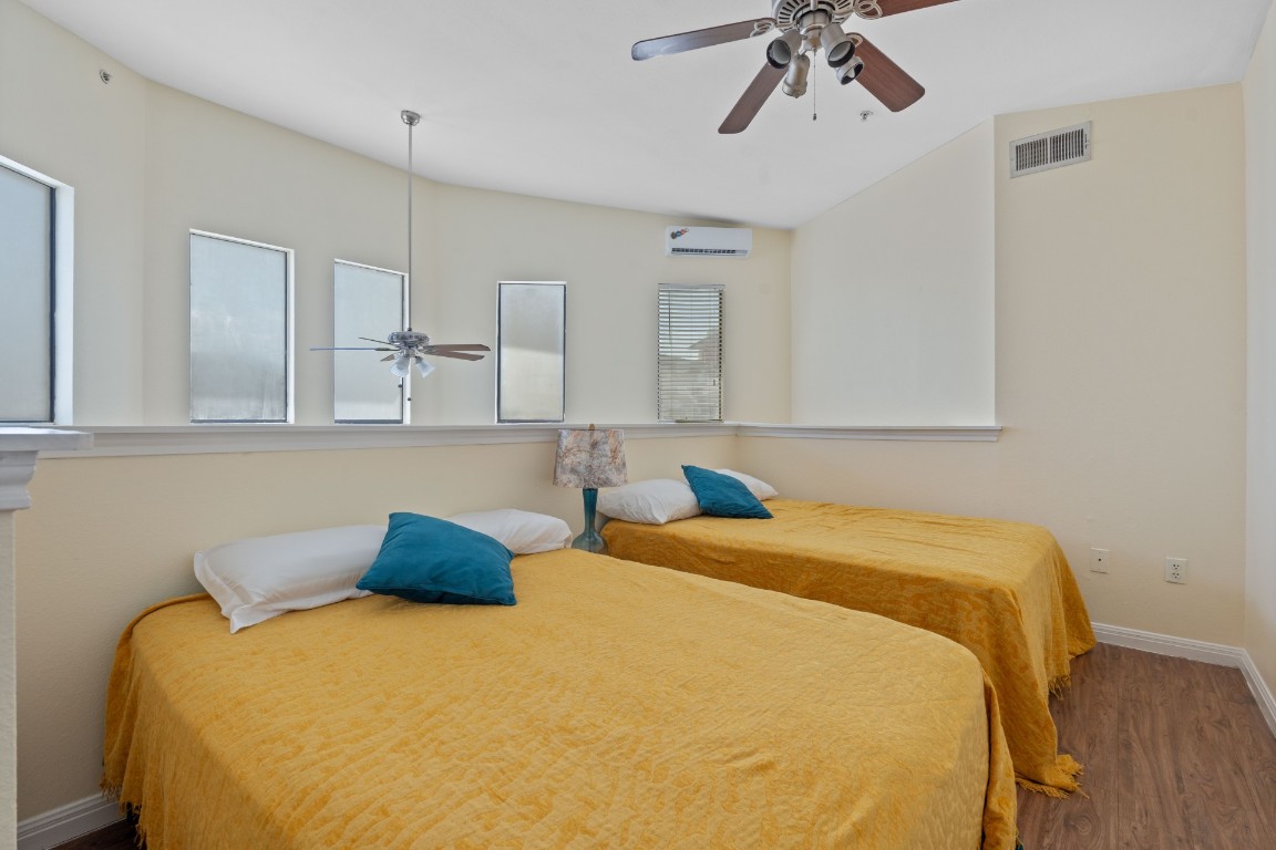 2502 Leon Street, Unit 501 Austin, TX 78705 - Photo 5 of 14 Bedroom with wood finished floors and a ceiling fan