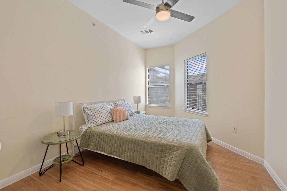 2502 Leon Street, Unit 501 Austin, TX 78705 - Photo 10 of 14 Bedroom with wood finished floors and ceiling fan