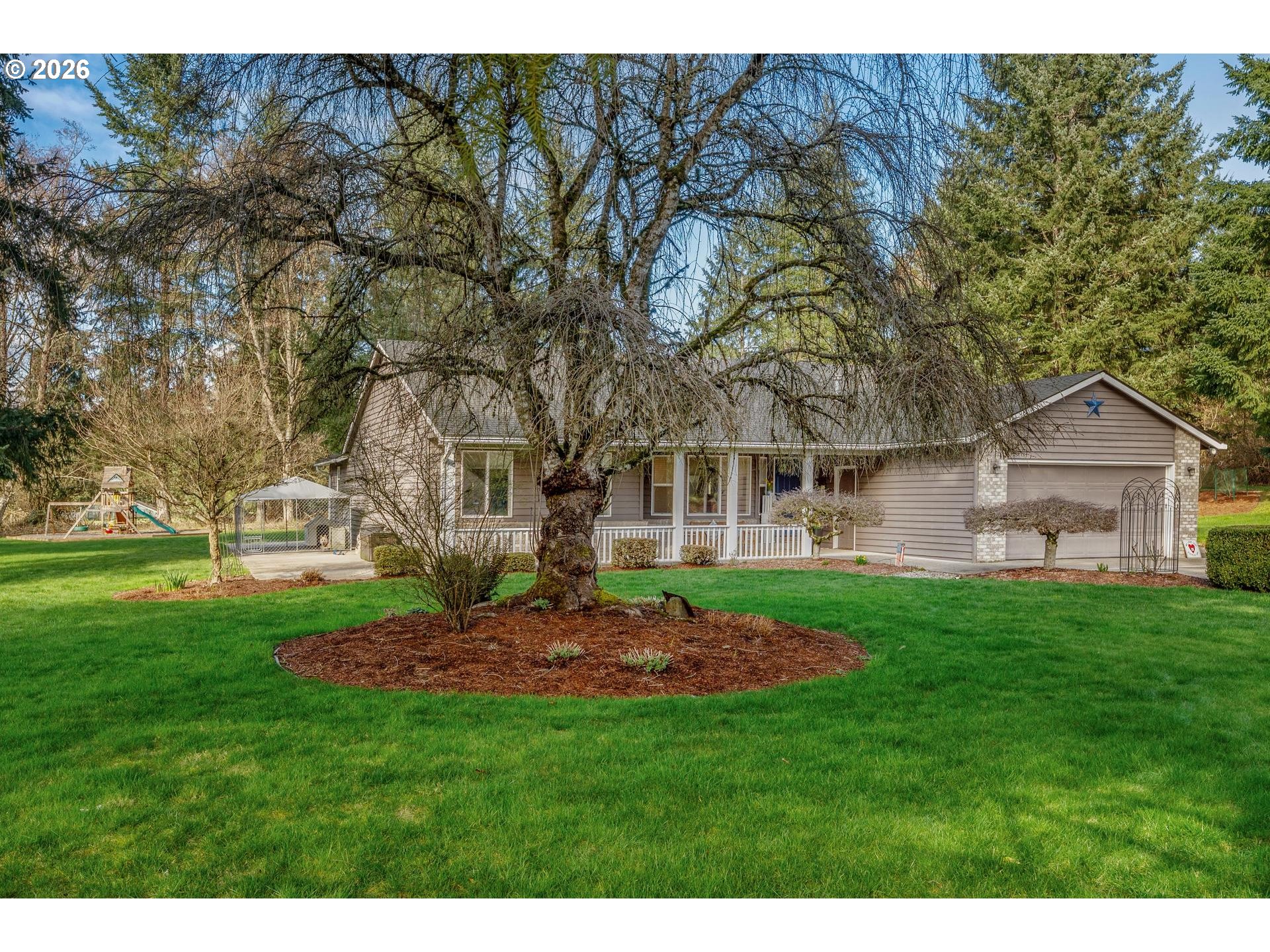 33261 Filbert Lane Warren, OR 97053 - Photo 3 of 35 a view of a backyard with table and chairs and wooden fence