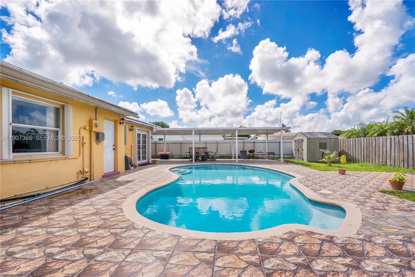 18922 Southwest 120th Court Miami, FL 33177 - Photo 16 of 29 a swimming pool with outdoor seating