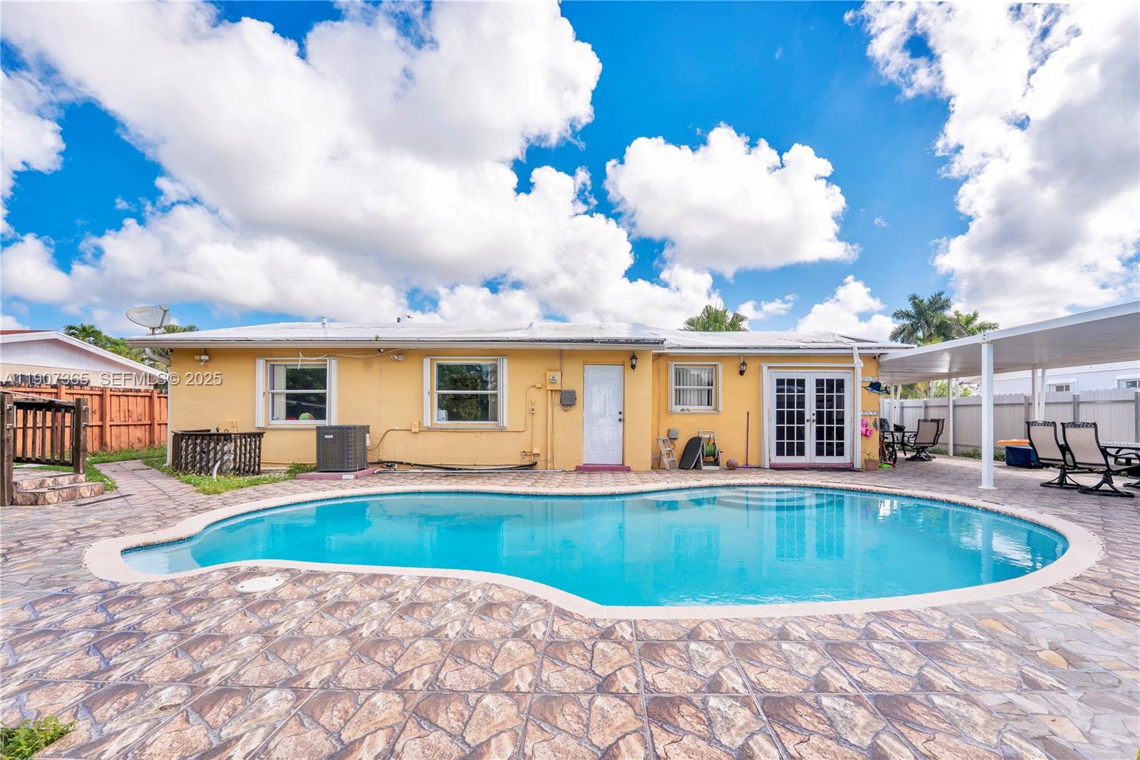 18922 Southwest 120th Court Miami, FL 33177 - Photo 17 of 29 a view of a house with swimming pool and sitting area