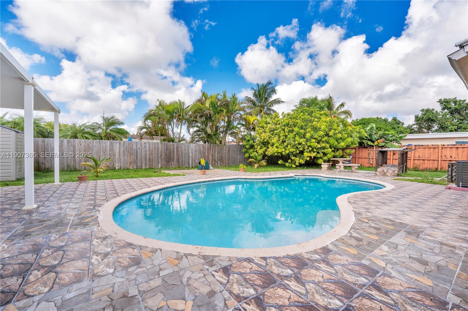 18922 Southwest 120th Court Miami, FL 33177 - Photo 18 of 29 a view of a swimming pool with a yard