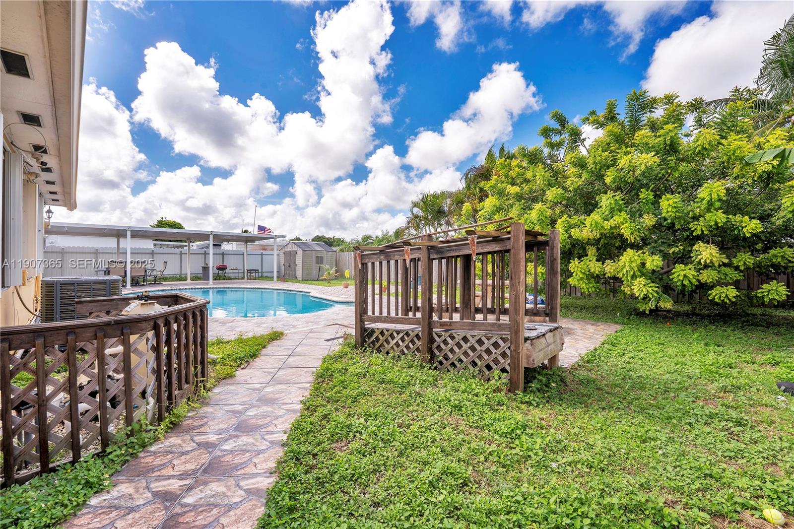 18922 Southwest 120th Court Miami, FL 33177 - Photo 19 of 29 a view of a house with wooden fence