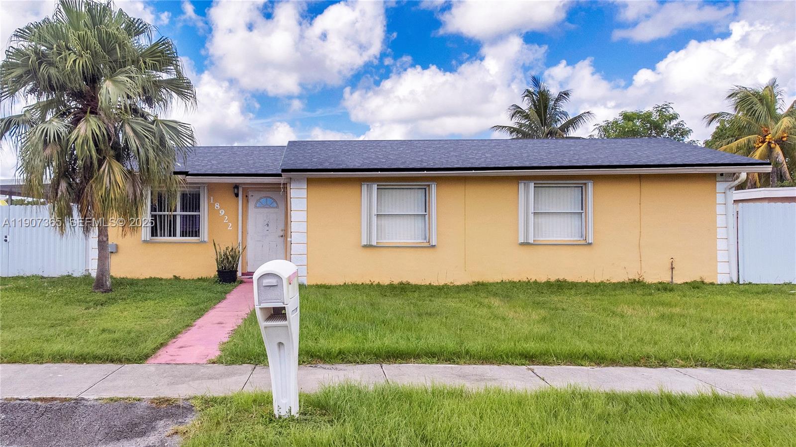 18922 Southwest 120th Court Miami, FL 33177 - Photo 20 of 29 a front view of a house with a yard