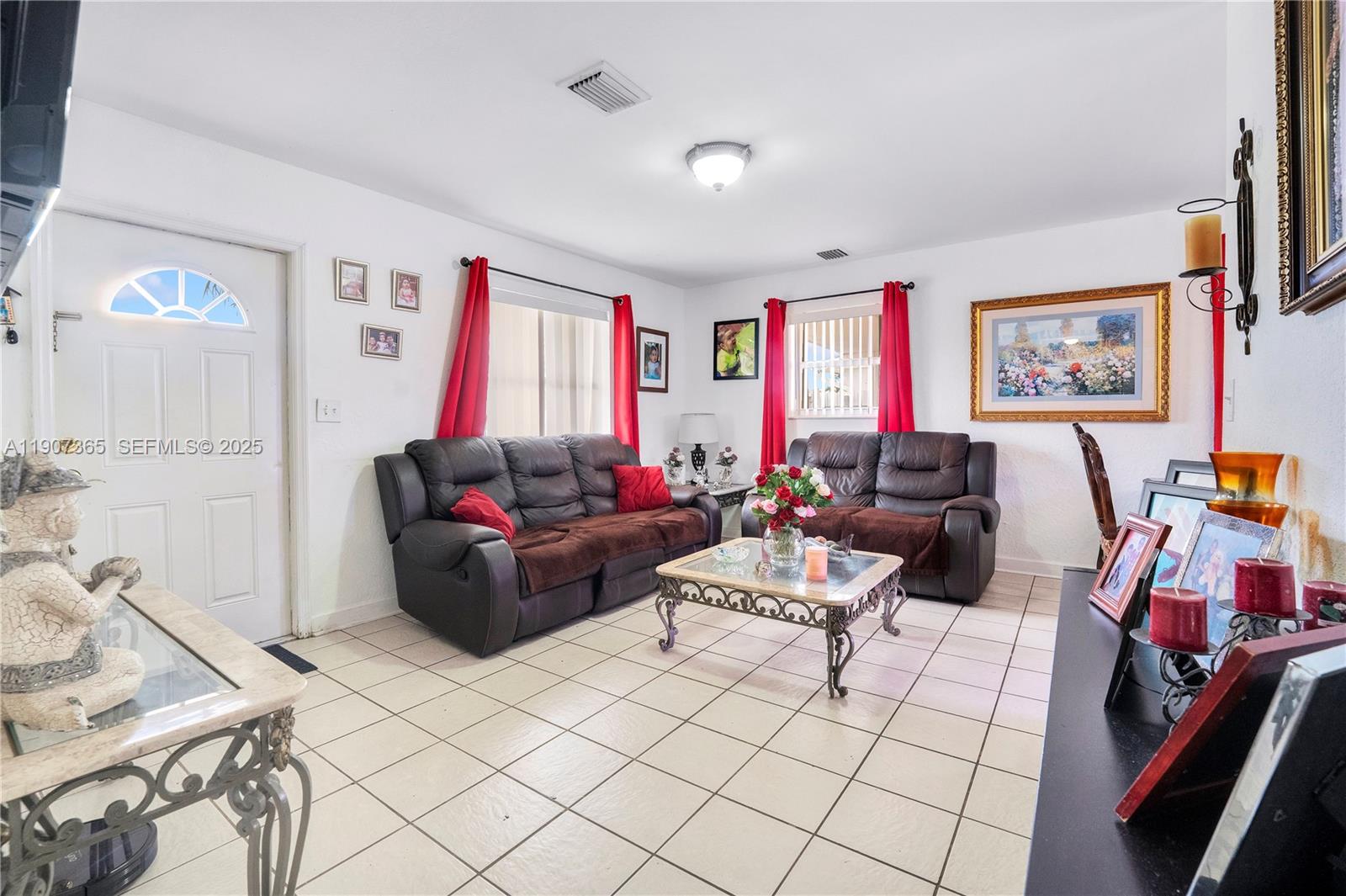 18922 Southwest 120th Court Miami, FL 33177 - Photo 2 of 29 a living room with furniture and a flat screen tv
