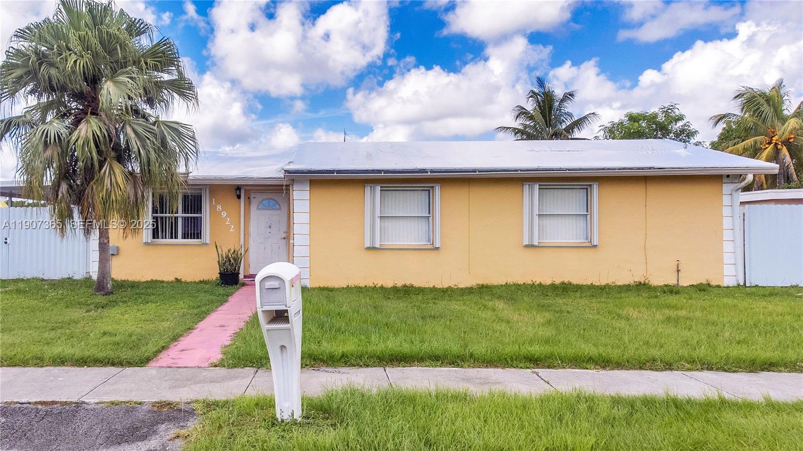 18922 Southwest 120th Court Miami, FL 33177 - Photo 26 of 29 a front view of a house with a yard