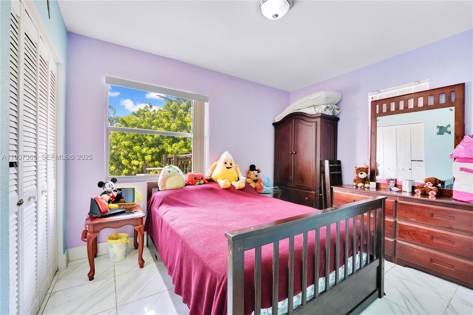 18922 Southwest 120th Court Miami, FL 33177 - Photo 10 of 29 a bedroom with a bed and a large window