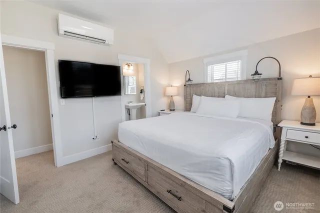 a bedroom with a bed and a flat screen tv