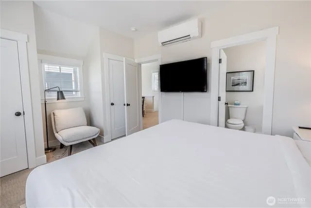 a bedroom with a bed and a flat screen tv