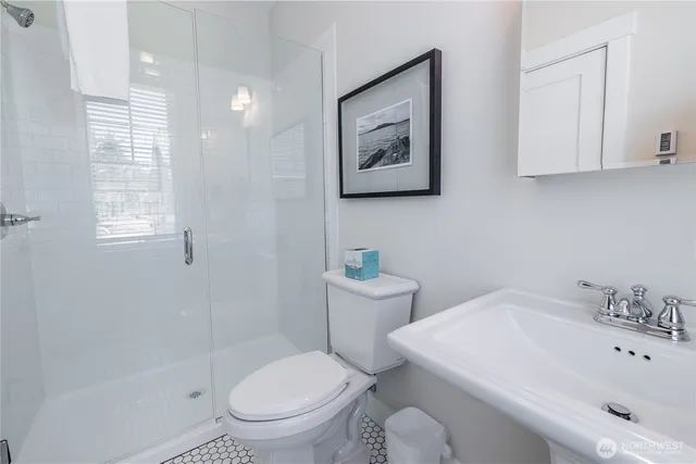 a white toilet sitting next to a bathroom sink