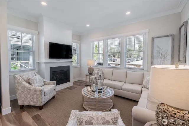 a living room with furniture a fireplace and a flat screen tv