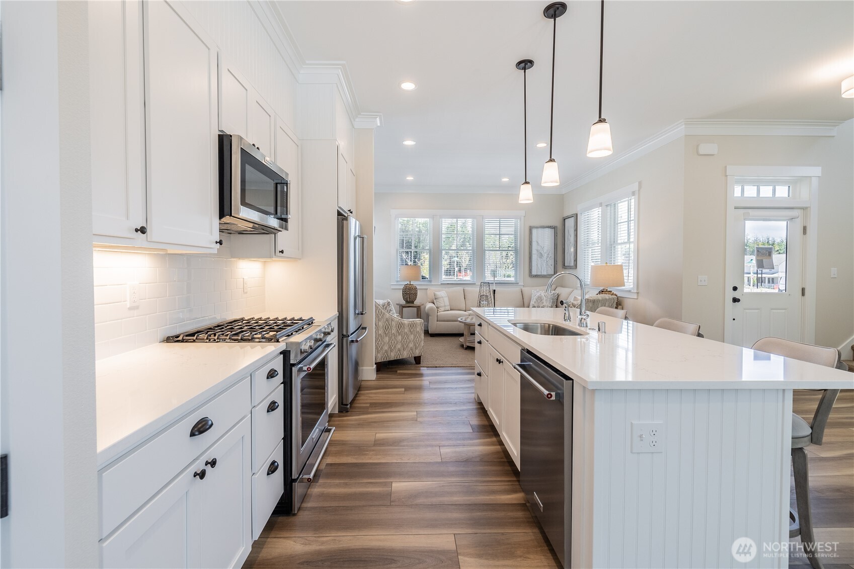 441 East Compass Street Pacific Beach, WA 98571 - Photo 10 of 26 a large kitchen with stainless steel appliances granite countertop a lot of counter space and wooden floor