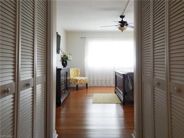 a view of a bedroom with a bed and a window