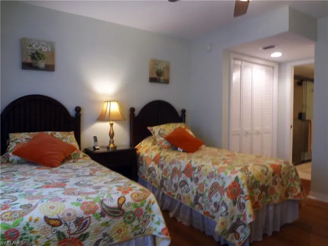 a bedroom with two beds and a lamp