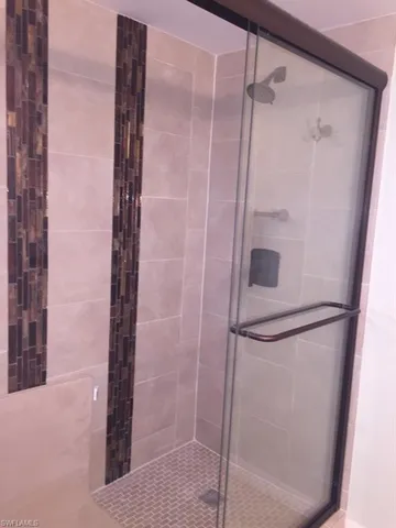 a bathroom with a glass shower door