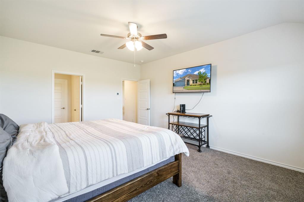 653 Bunker Hill Road Houston, TX 77024 - Photo 15 of 36 Bedroom with dark colored carpet and ceiling fan