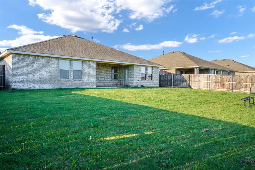 653 Bunker Hill Road Fate, TX 75189 - Photo 23 of 36 Rear view of house with a patio area, a fenced backyard, brick siding, and roof with shingles