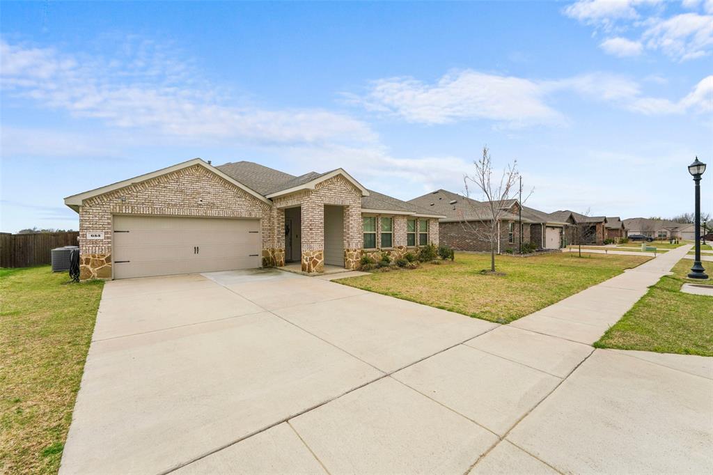 653 Bunker Hill Road Fate, TX 75189 - Photo 27 of 36 View of front of house featuring brick siding, concrete driveway, a garage, and a shingled roof