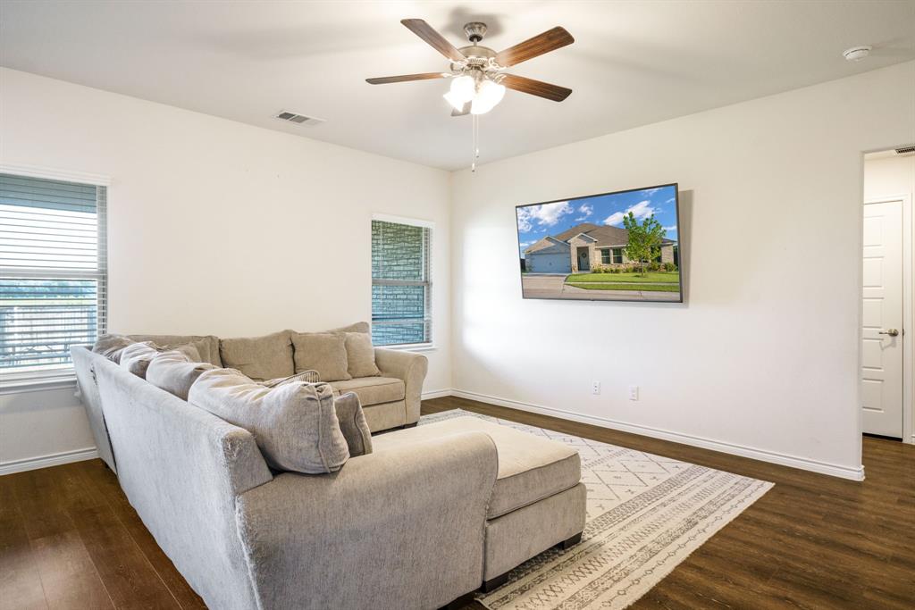 653 Bunker Hill Road Houston, TX 77024 - Photo 8 of 36 Living area featuring dark wood-style flooring and ceiling fan