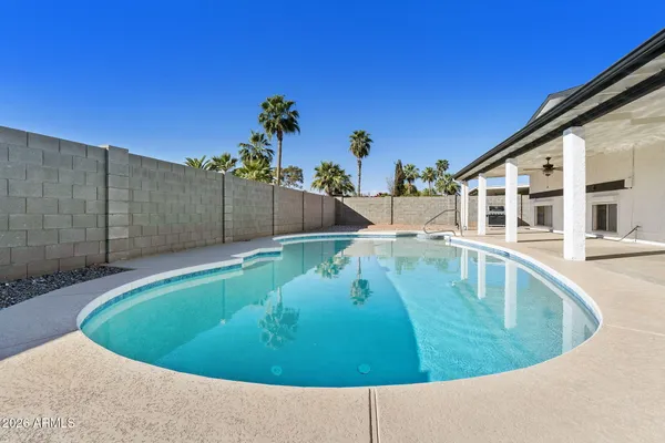 a view of a swimming pool with a chairs