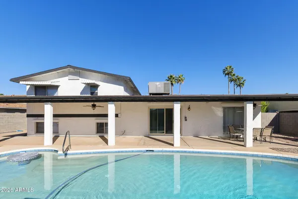 a view of a house with a backyard