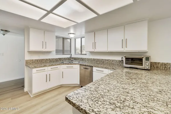 a kitchen with stainless steel appliances granite countertop a stove a sink and a granite counter tops