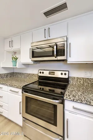 a kitchen with appliances and cabinets