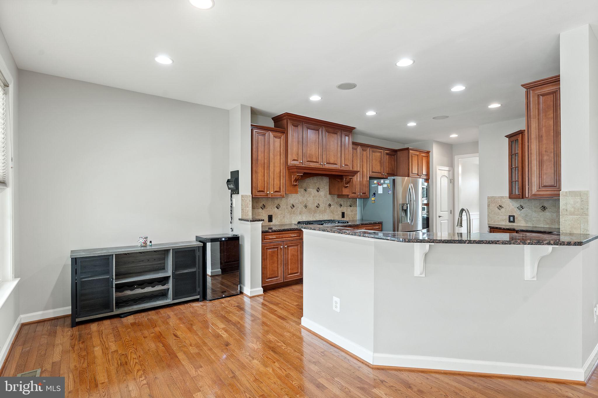 42524 Rowderbury Square Chantilly, VA 20152 - Photo 35 of 73 a kitchen with stainless steel appliances granite countertop a stove a sink and a refrigerator