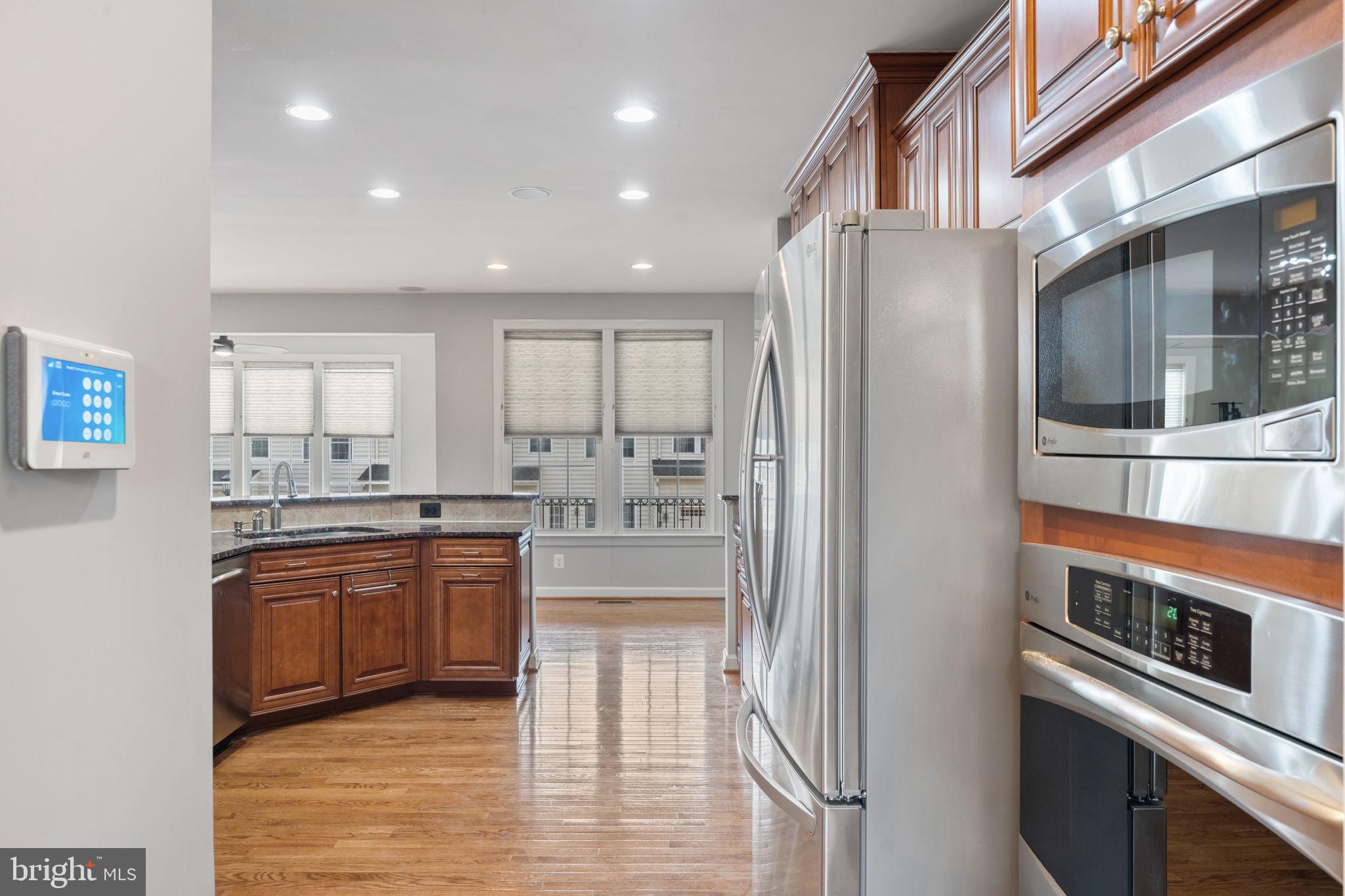 42524 Rowderbury Square Chantilly, VA 20152 - Photo 37 of 73 a kitchen with stainless steel appliances granite countertop a refrigerator and a stove top oven