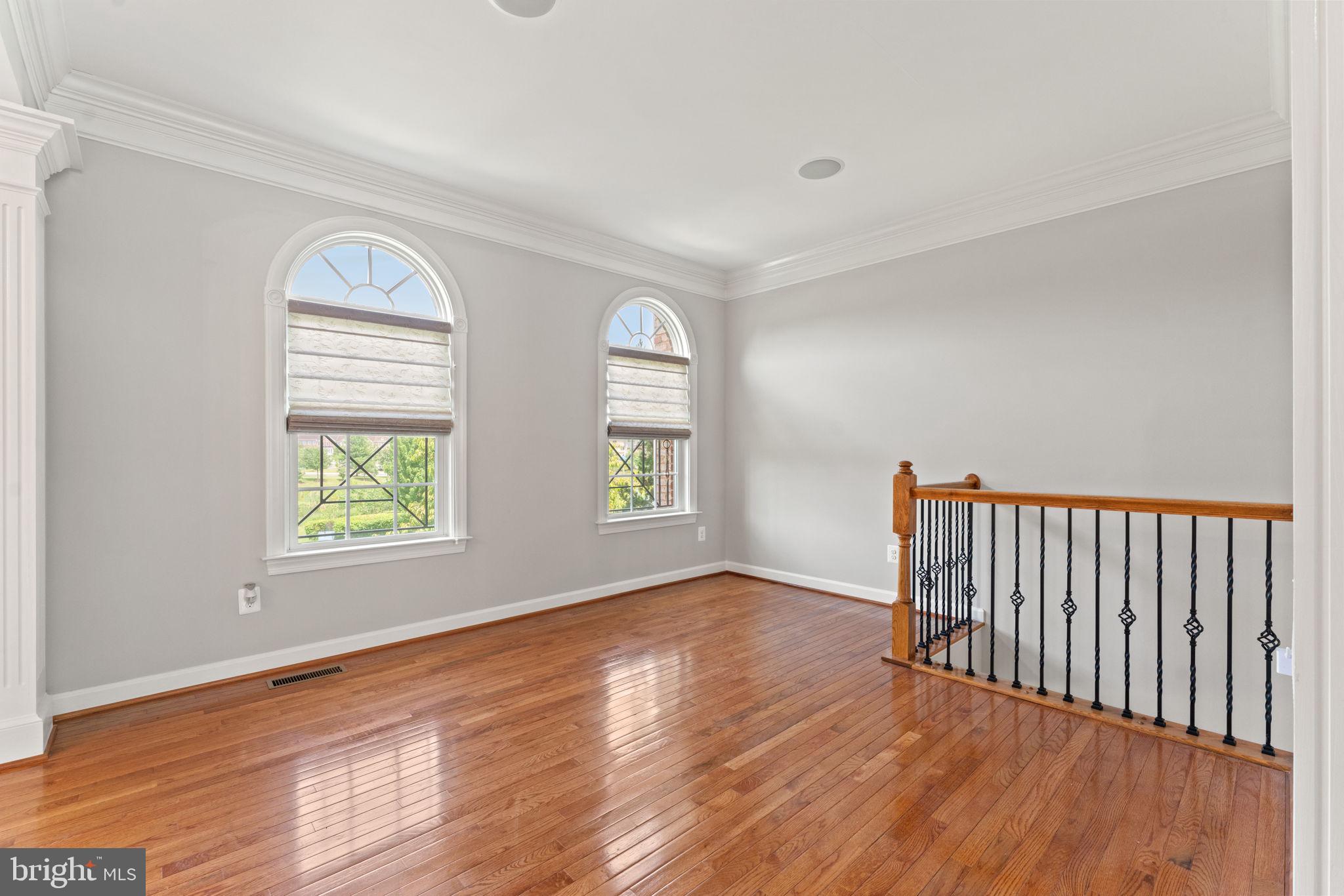 42524 Rowderbury Square Chantilly, VA 20152 - Photo 4 of 73 a view of an empty room with wooden floor and a window